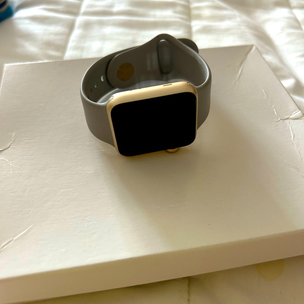 Series 2 Apple Watch 35mm gold frame with gray rubber band . Hardly used.